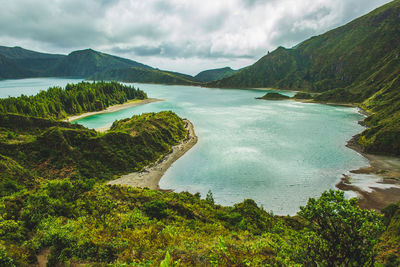 Scenic view of lake and mountains against sky