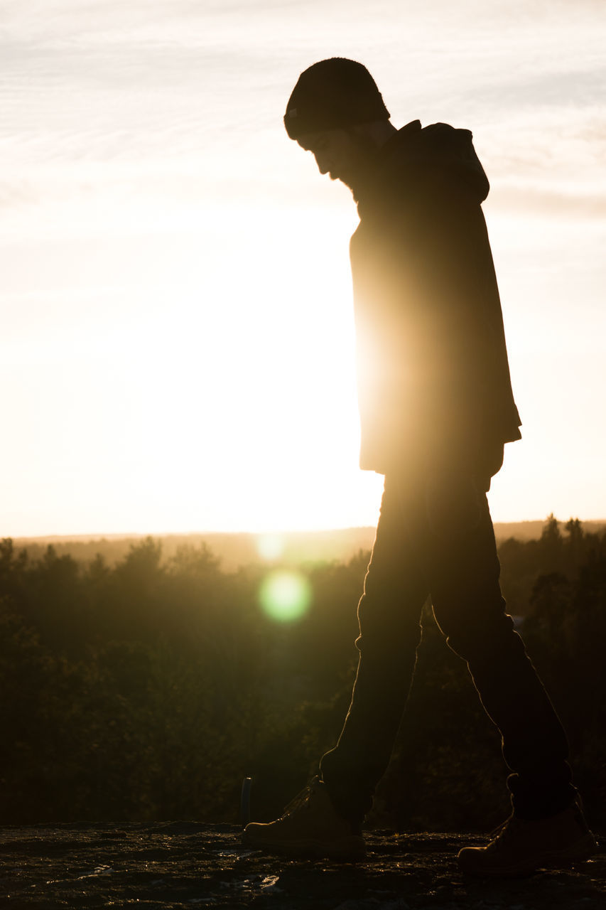 sunset, silhouette, full length, standing, sun, sunlight, real people, one person, lens flare, outdoors, side view, nature, sky, leisure activity, men, water, lake, scenics, lifestyles, beauty in nature, day, people