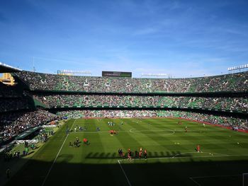 High angle view of people on soccer field against sky