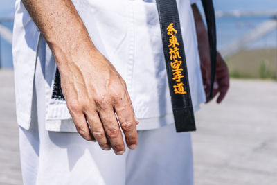 Karate expert with relaxed hands, close up image