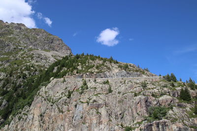 Low angle view of rocky mountains against sky