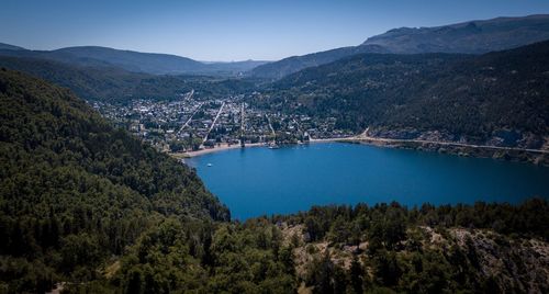 High angle view of lake and mountains against sky