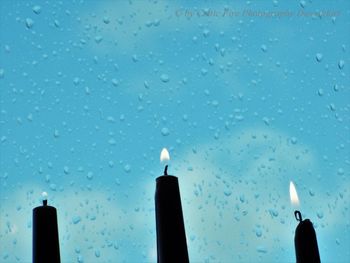 Low angle view of raindrops on glass window