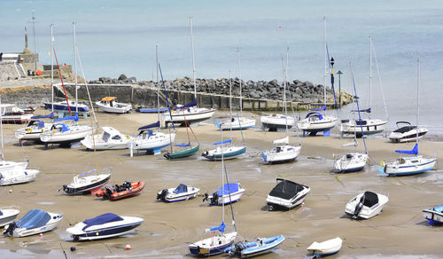 High angle view of boats moored at harbor against sky