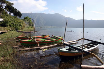 Boats moored at lakeshore