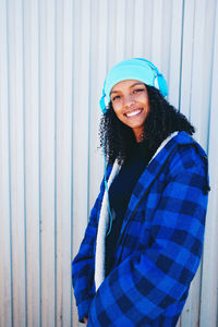 Portrait of smiling young woman standing in snow