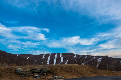 Scenic view of mountains against blue sky