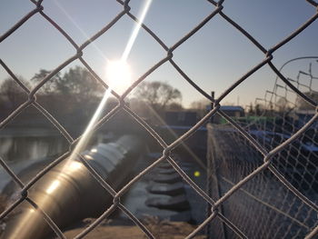 Close-up of chainlink fence against sky