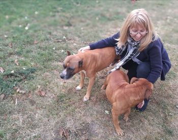 Woman with dog on field