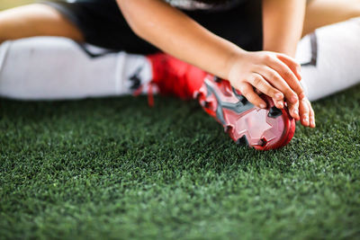 Low section of person with ball on grass