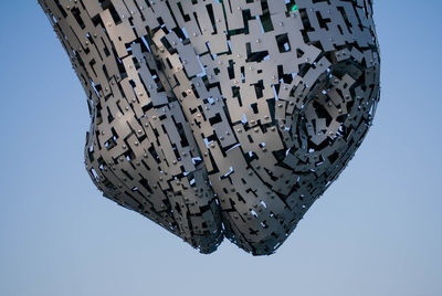 Low angle view of built structure against clear blue sky