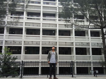 Full length of man standing against building in city