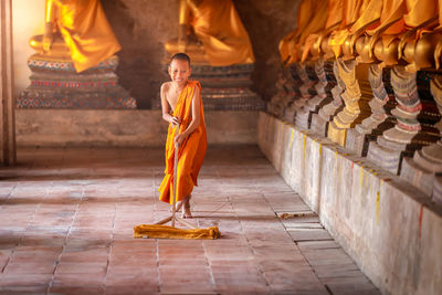 Full length of a buddha statue in temple