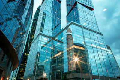 Low angle view of modern buildings against sky in city