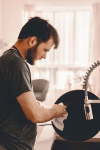 Side view of young man using mobile phone