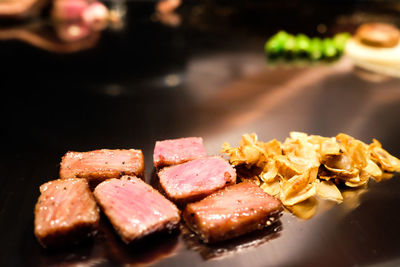 Beef served with roasted garlic on plate