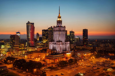 High angle view of city lit up at night