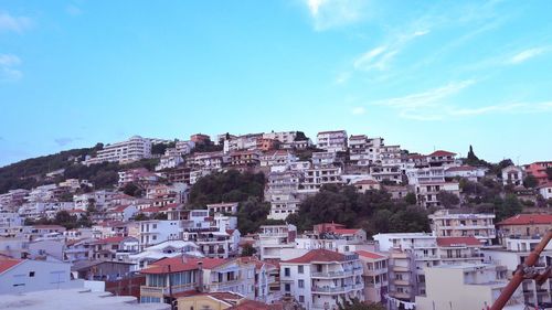 Buildings in city against blue sky