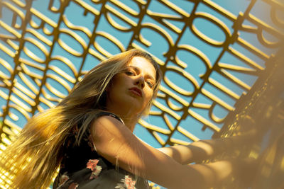 Low angle view of woman looking away outdoors