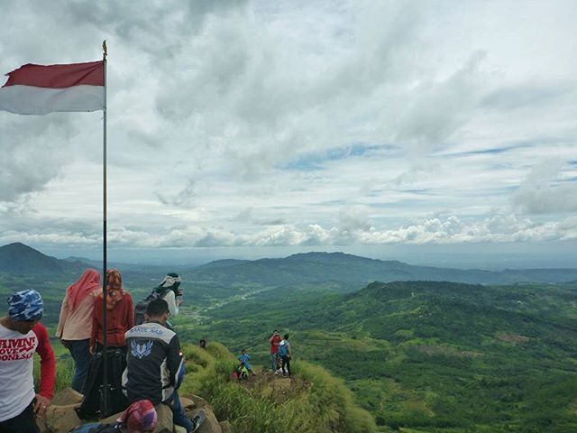 sky, mountain, cloud - sky, cloudy, landscape, cloud, men, mountain range, scenics, tranquility, leisure activity, lifestyles, tranquil scene, nature, beauty in nature, grass, day, weather, non-urban scene