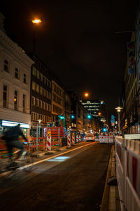 Illuminated city street at night