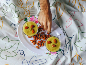 Cropped image of hand taking almonds