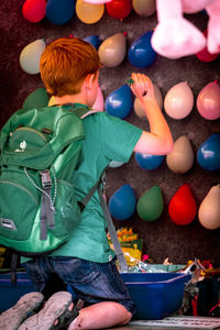 Rear view of boy playing with toy