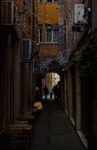 Men hanging in illuminated city at night