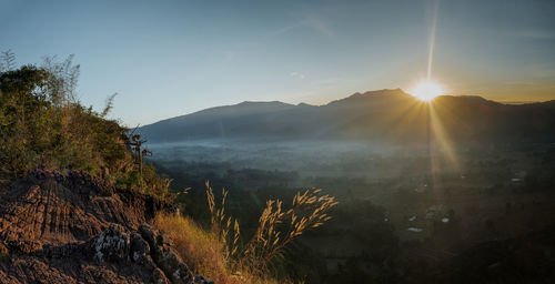 Scenic view of mountains against sky at sunset