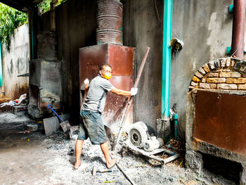 Rear view of man working at construction site