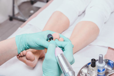 Cropped image of chiropodist with patient in clinic