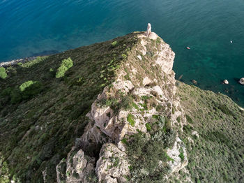 High angle view of cliff by sea