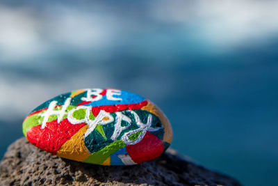 Close-up of multi colored ball on rock