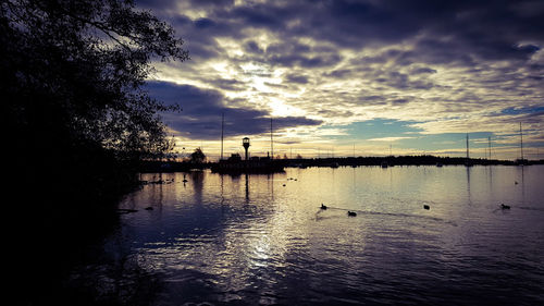 Scenic view of lake against sky during sunset