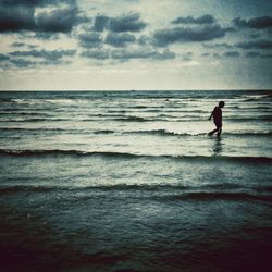 Scenic view of sea against cloudy sky