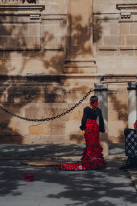 Full length rear view of woman walking in city