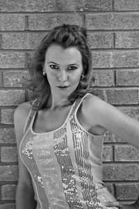 Portrait of beautiful woman standing against wall