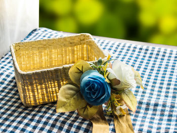 Close-up of rose bouquet in basket on table