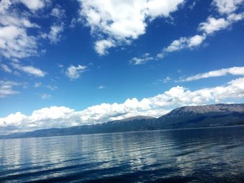 Scenic view of lake against cloudy sky