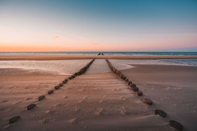 Scenic view of beach against sky during sunset