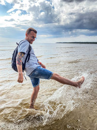 Full length of man on beach against sky