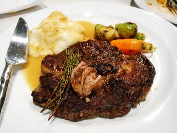 Close-up of meat with vegetable served in plate