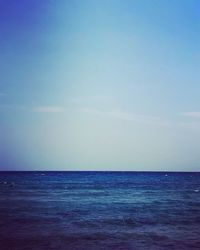 Scenic view of sea against blue sky