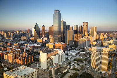 Aerial view of buildings in city against clear sky