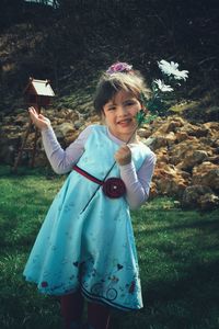 Portrait of cute girl standing on field
