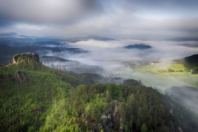 Scenic view of mountains against cloudy sky