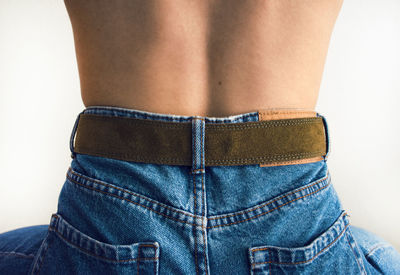 Rear view of woman standing against white background