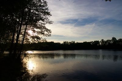 Scenic view of lake against sky at sunset