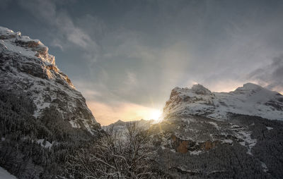 Scenic view of snowcapped mountains against sky during sunset