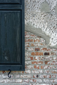 Low angle view of window on wall of old building